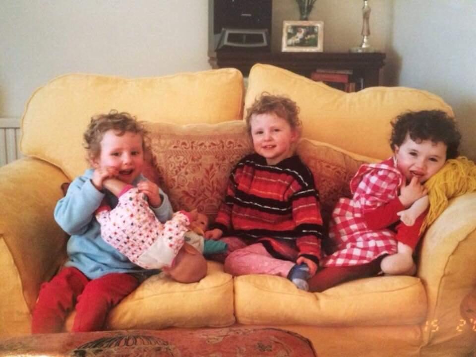 Annie, Martha and Ellie on a yellow sofa when young